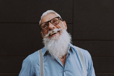 Close-up of senior hipster against wall