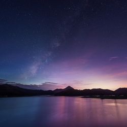 Scenic view of lake against star field at night