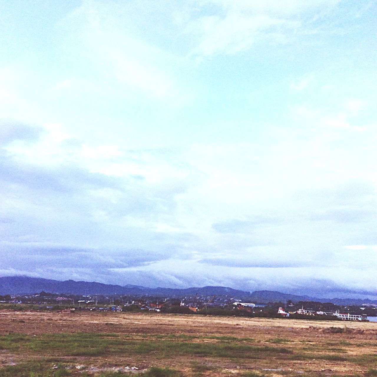 mountain, landscape, sky, tranquil scene, scenics, tranquility, mountain range, cloud - sky, beauty in nature, nature, field, cloud, cloudy, non-urban scene, day, hill, built structure, remote, building exterior, outdoors