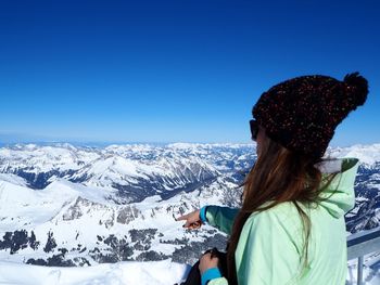 Man standing on mountain against clear sky