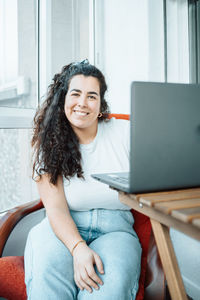 Young woman using laptop at home