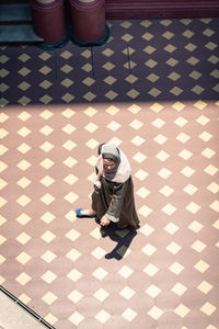 High angle view of man sitting on floor