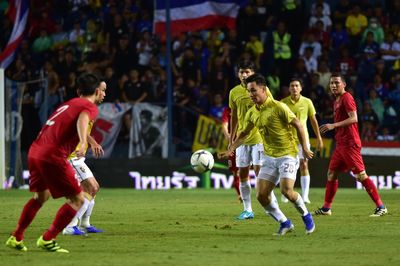 Group of people playing soccer on field