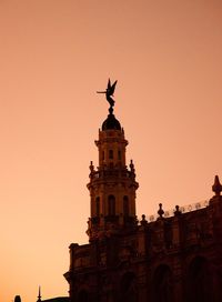 Low angle view of statue against sky during sunset