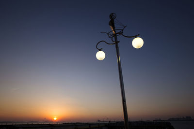 Low angle view of illuminated street light against sky at night