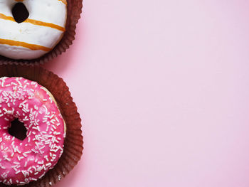 High angle view of cupcakes against pink background