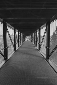 Empty footbridge along railings