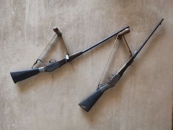 High angle view of weapons hanging on wall