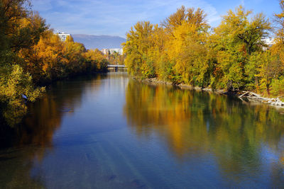 Scenic view of river against sky during autumn