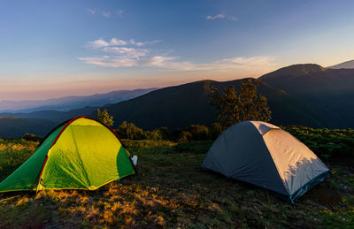 Camping tents in front of a beautiful mountain landscape