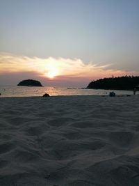 Scenic view of beach against sky during sunset