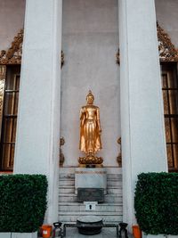 Statue against building