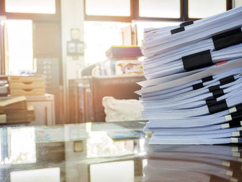 Close-up of papers stacked on table