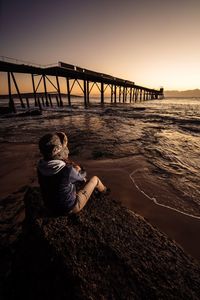 Pier on sea at sunset