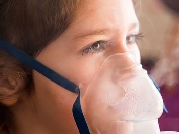 Close-up portrait of a boy drinking glass