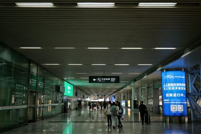 Rear view of people walking in airport