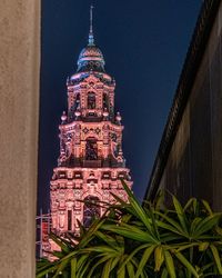 Low angle view of buildings against sky at night