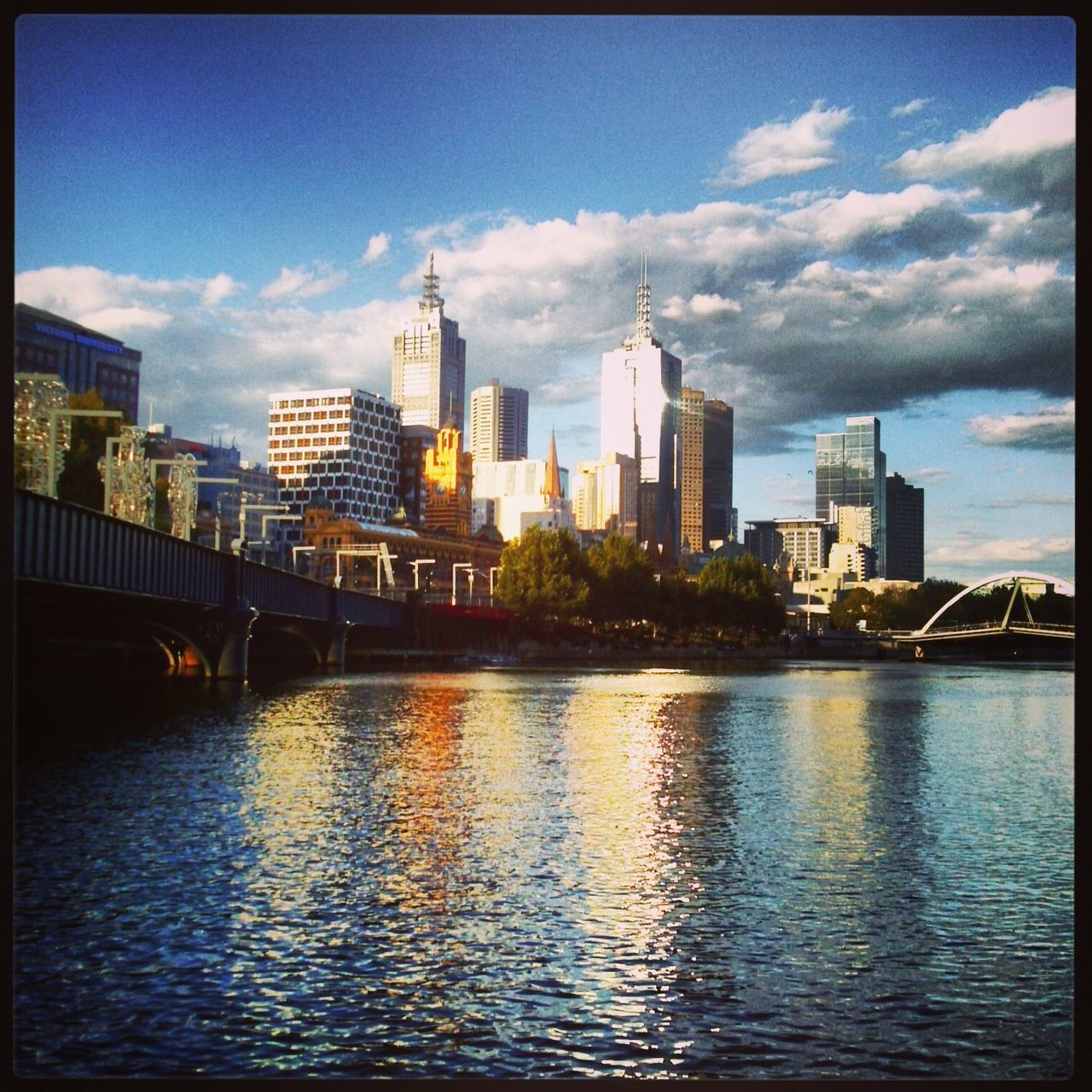 architecture, building exterior, built structure, city, skyscraper, cityscape, sky, water, river, waterfront, skyline, tower, transfer print, urban skyline, cloud - sky, modern, cloud, financial district, tall - high, capital cities