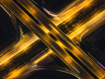 High angle view of light trails on highway at night