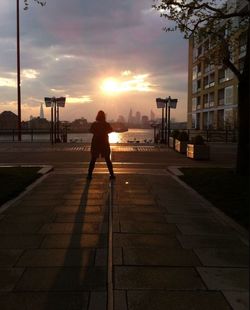 Full length of man on road in city against sky