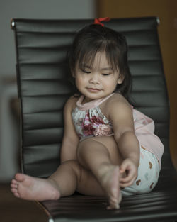 Cute baby girl sitting at home