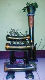 Close-up of old machinery on table against wall