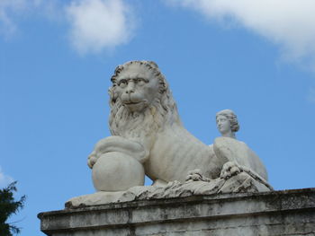 Low angle view of statue against blue sky