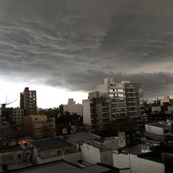 Buildings against cloudy sky