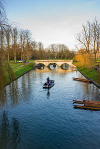 People in river against sky