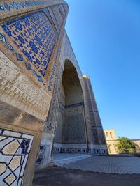 Low angle view of historical building against blue sky