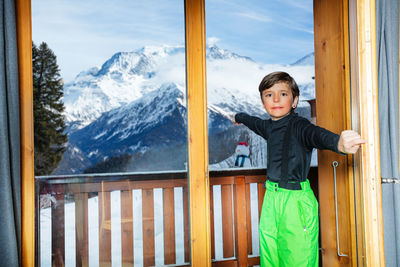 Portrait of girl standing against mountain range