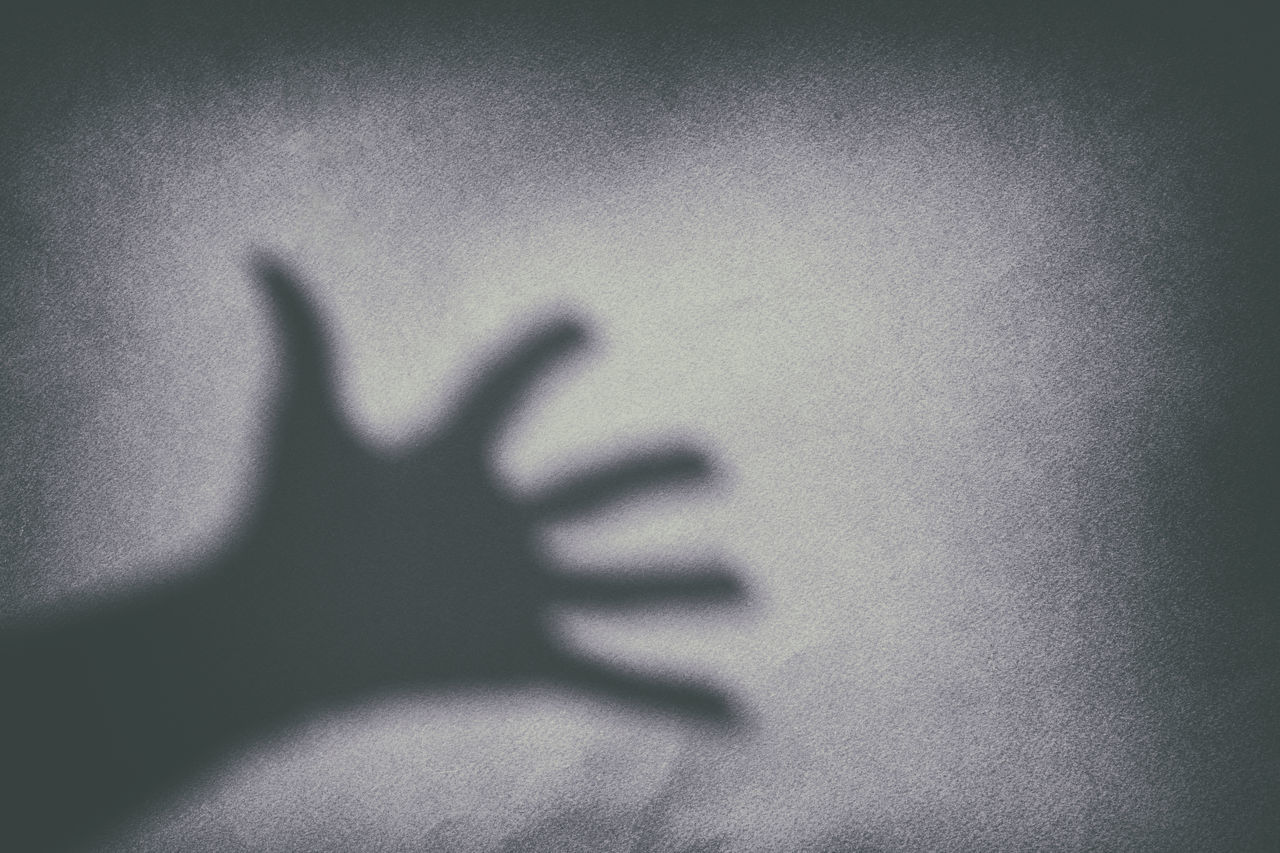 SHADOW OF HUMAN HAND ON WALL