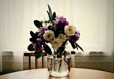 Close-up of flower vase on table at home