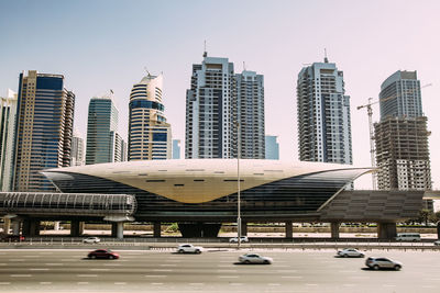 Modern buildings in city against clear sky