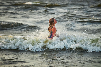 Side view of woman swimming in sea