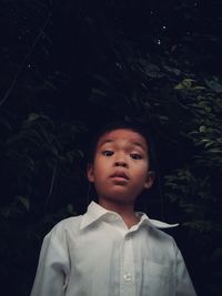 Portrait of boy standing outdoors