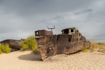 Rusty ships stranded in the sand after the aral sea in uzbekistan has dried up.