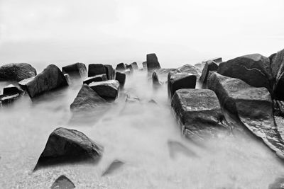 Panoramic shot of rocks in sea against sky