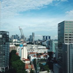 Modern buildings against cloudy sky