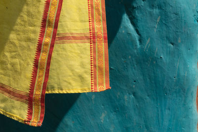 High angle view of textile against blue wall