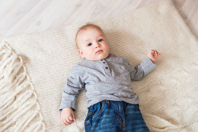 Portrait of cute baby lying on blanket