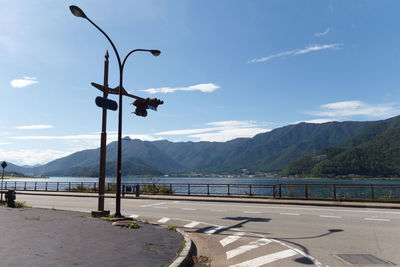 Street by mountains against sky