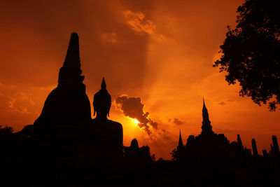 Silhouette statue against sky during sunset