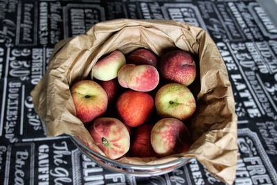 Close-up of apples in basket on table