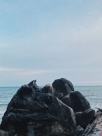 Rocks on beach against sky