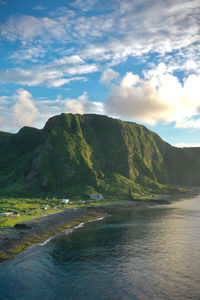 Scenic view of sea and mountains against sky