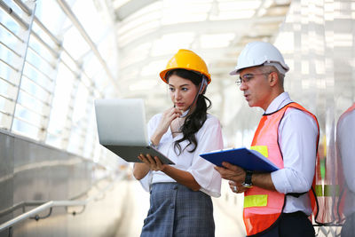 Low angle view of man working with mobile phone