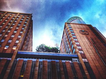 Low angle view of building against cloudy sky