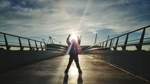 Sunset over my son walking on suspension bridge at the etihad stadium