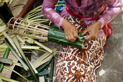 High angle view of woman holding basket